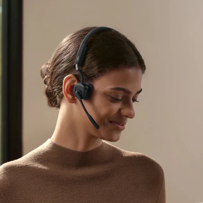 Een vrouw draagt de Shokz OpenMeet UC bone conduction en air conduction open-ear headset