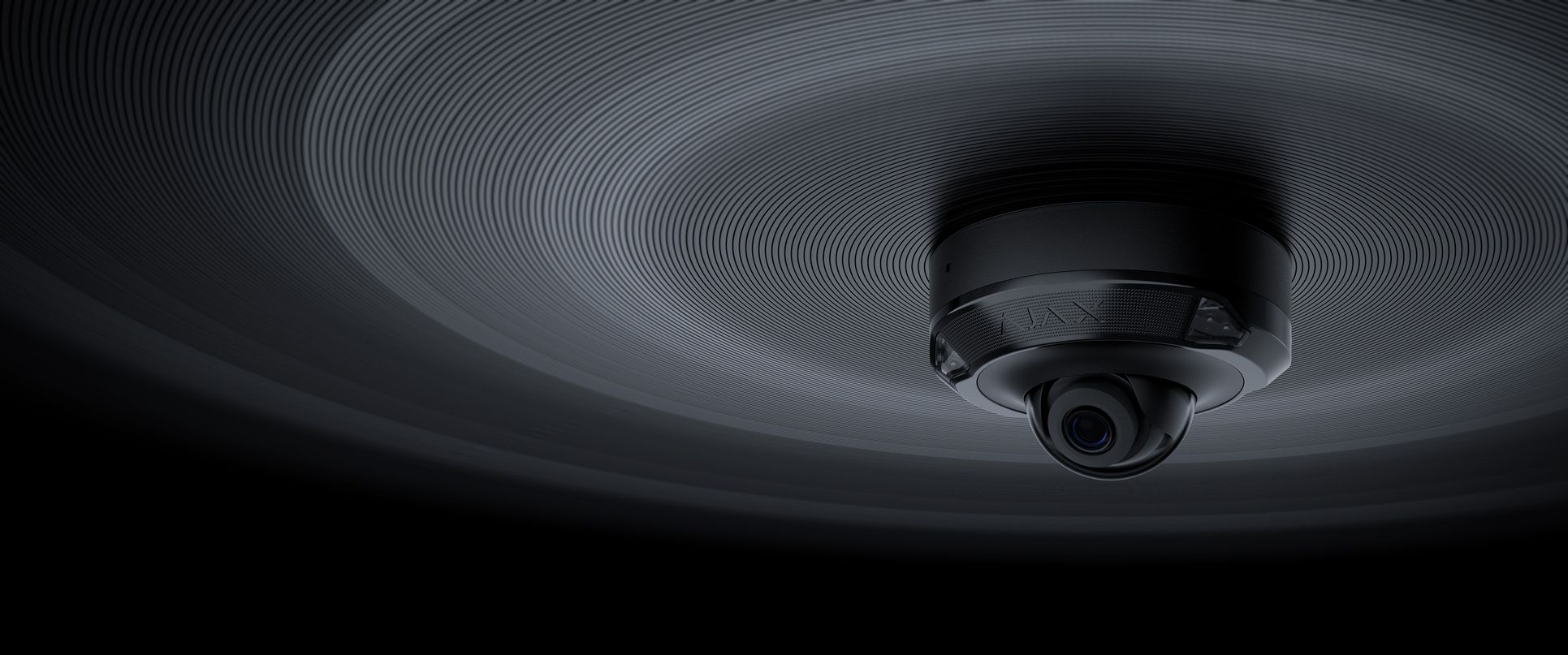 black ajax dome camera on black ceiling